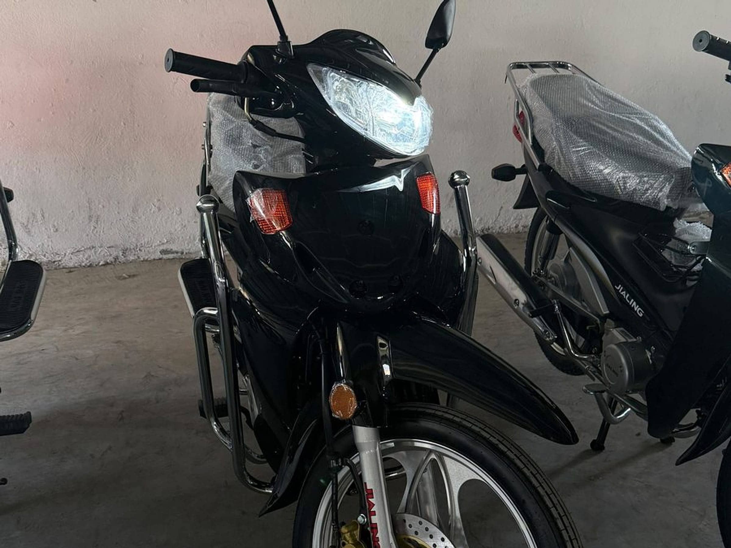 New Jialing motorcycles, headlight on, in the depot of Jialing Tunisia, official importer